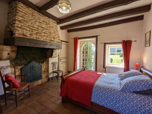a bedroom with a bed and a fireplace at Gîte avec 3 chambres, jardin privatif, 12 vélos, proche de Cognac - FR-1-653-205 in Cherves-de-Cognac