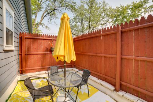 a patio with a table and a yellow umbrella at Riverside Niles Retreat with Fire Pit and Grill! in Niles