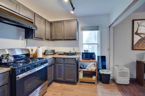a kitchen with wooden cabinets and a stove top oven at Riverside Niles Retreat with Fire Pit and Grill! in Niles