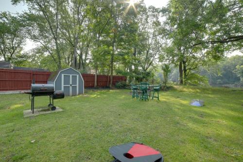 a backyard with picnic tables and a grill at Riverside Niles Retreat with Fire Pit and Grill! in Niles
