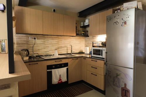 a kitchen with a refrigerator and a stove with a towel on the oven at B&B Casa V-Ale in Collegno