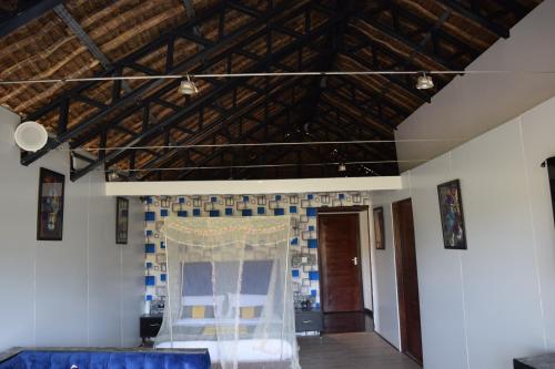 Zimmer mit einem blauen und weißen Vorhang und einer Decke in der Unterkunft Kitumo Mara Lodges in Mara Simba