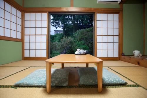 a room with a table in front of a door at Stay Nikko Guesthouse in Nikko