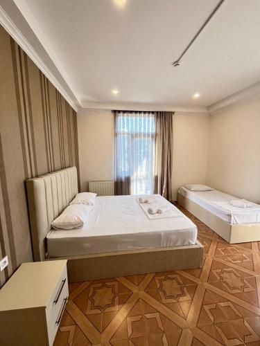 a bedroom with two beds and a window at IRISE in Batumi