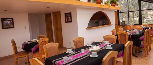a group of tables and chairs in a room at Maimara Hotel in Huaraz