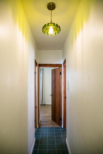 a hallway with a door and a chandelier at N1 Condos in San Juan