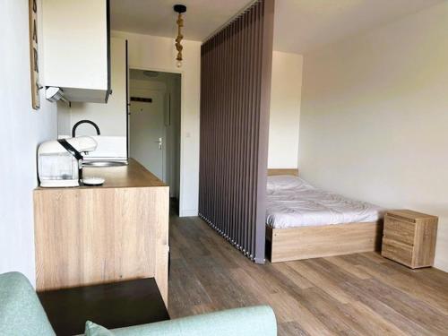une petite chambre avec un lit et une cuisine dans l'établissement HYERES PORT Studio 2 personnes 2 enfants vue HIPPODROME, à Hyères