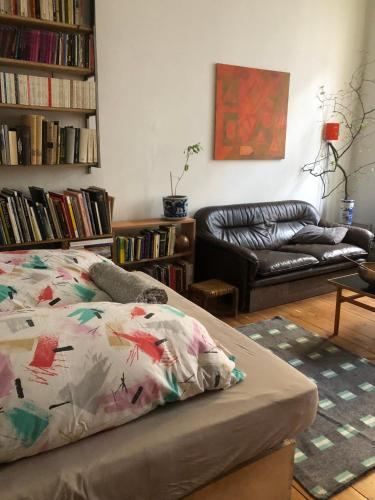 a living room with a bed and a couch at Imagination in the Heart of the city in Berlin