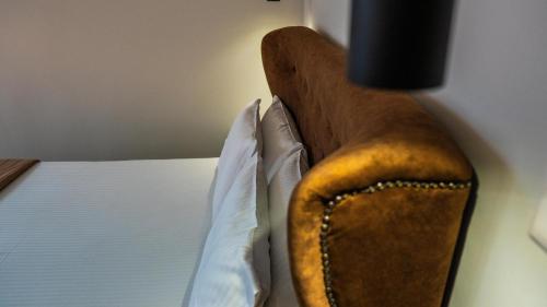 a close up of a bed with two pillows at Rooms Batalogianni in Kalabaka