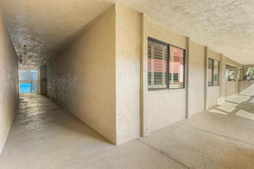 an empty hallway of a house with a window at Del Mar Gem condo in Solana Beach