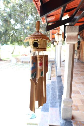 a bird feeder hanging from a building at Athulya Resort -Leisure and Luxury cottages from EMBEHolidays in Kottaikadu