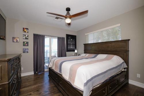 a bedroom with a bed and a ceiling fan at Harbour House at the Inn 212 in Fort Myers Beach
