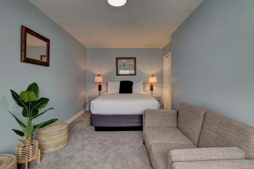 a hotel room with a bed and a couch at Inn of the Four Winds Seaside Oceanfront in Seaside