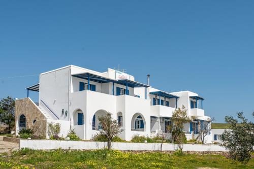 a white building with a blue sky in the background at Galini me thea in Chrissi Akti