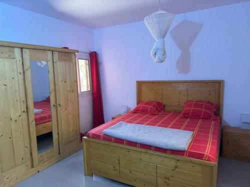 Ένα ή περισσότερα κρεβάτια σε δωμάτιο στο Villa à Malicounda 3 chambres, piscine, calme et confort à 10 min de Saly