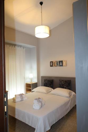 a bedroom with two beds with towels on them at The Seashell apartment in Keramoti