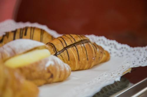 two pastries are sitting on a white plate at Il Vecchio Mulino in Brecciarola