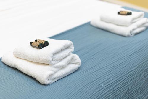 two towels are stacked on top of a bed at Charming 1BR Flat in the Heart of City of London in London