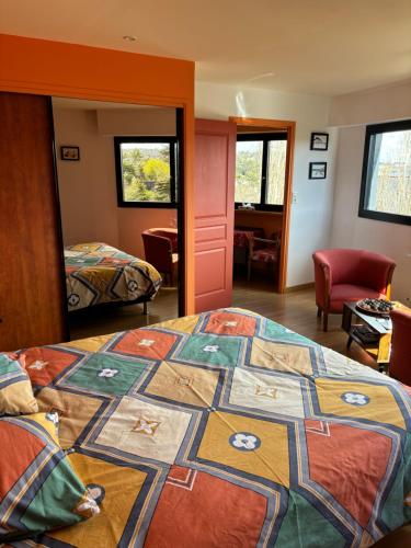 a bedroom with a bed with a quilt on it at Nid de Pie in Crozon