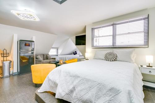 a bedroom with a white bed and a couch at Ocean City Loft-Style Apt, Close to Beaches! in Ocean City
