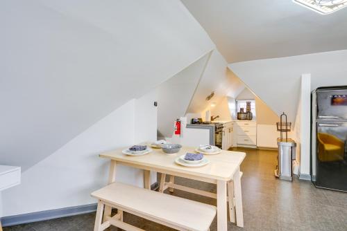 a dining room with a table and a refrigerator at Ocean City Loft-Style Apt, Close to Beaches! in Ocean City