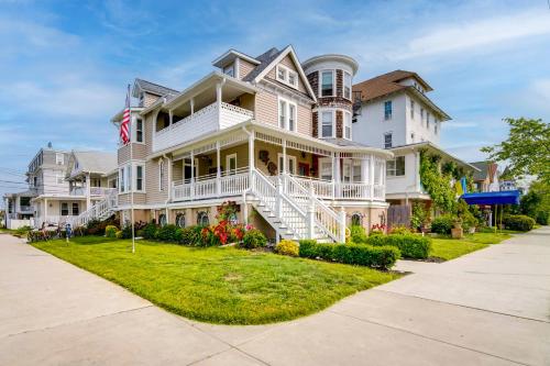 a large white house with a lawn in front of it at Ocean City Loft-Style Apt, Close to Beaches! in Ocean City