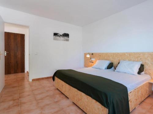 a bedroom with a large bed with blue pillows at Magaluf Beach I Calviá I Seaview I Apartment in Calvia Town