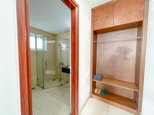 a bathroom with a shower and a glass door at Sunny Motel Tuần Châu in Ha Long