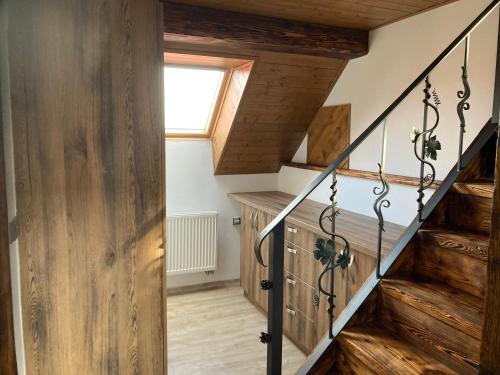 a staircase in a house with wooden walls and a window at ubytování v podkroví in Jindrichuv Hradec