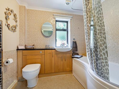 a bathroom with a toilet and a sink and a tub at 1 bed property in Taunton 58511 in Taunton