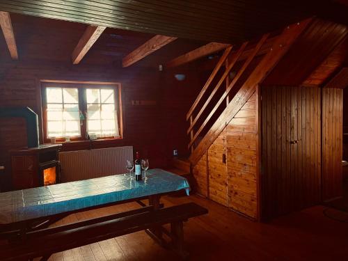 a dining room with a table and a window at Tündér Farm in Zirc