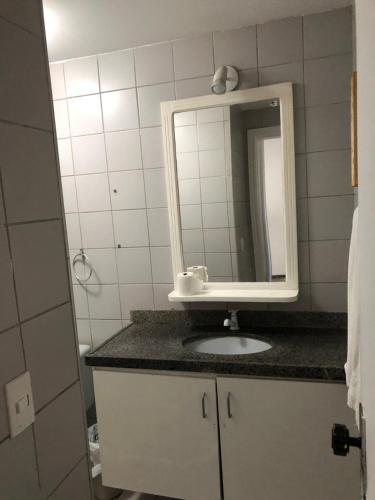 a bathroom with a sink and a mirror at Via Venetto Flat Temporada in Fortaleza