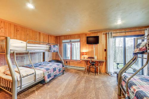a bedroom with two bunk beds and a tv at Pristine Resort Townhome 2 Mi to Seven Springs Mtn in Champion