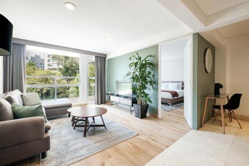 a living room with a couch and a table at Lincoln Square Polanco by RentinBA in Mexico City