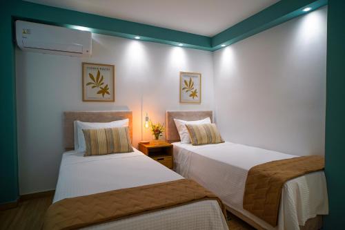 two beds in a hotel room with two at Marant Luxury Apartment in Agios Rokkos