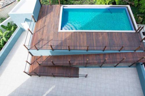 an overhead view of a swimming pool with a wooden deck at Journey`s End with Prohomesja at Bromptons in Kingston