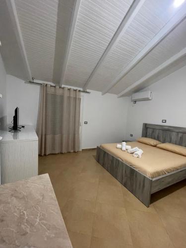 a bedroom with a bed with towels on it at Eveline Boutique Apartments in Sarandë