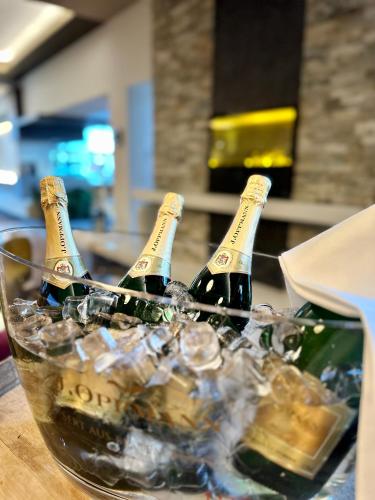 two bottles of champagne in a bowl of ice at Hotel Peterhof - urban lifestyle Kempten in Kempten