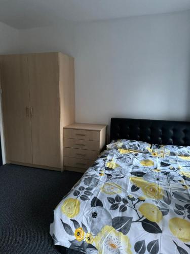 um quarto com uma cama com colcha floral em Northampton town em Kingsthorpe