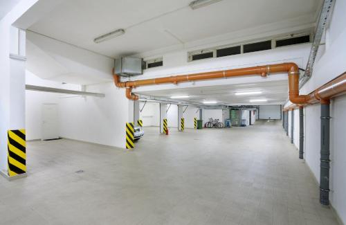 an empty room with orange pipes on the wall at Garni Hotel Crystal in Kraljevo