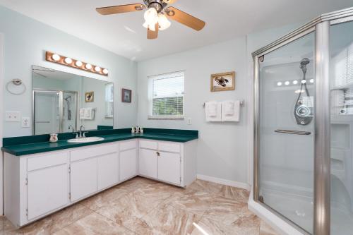 a bathroom with a sink and a shower at Castaway Cottage in Fort Myers Beach