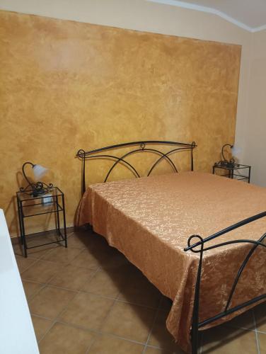 a bedroom with a bed and two side tables at podere il poggetto in Lorenzana
