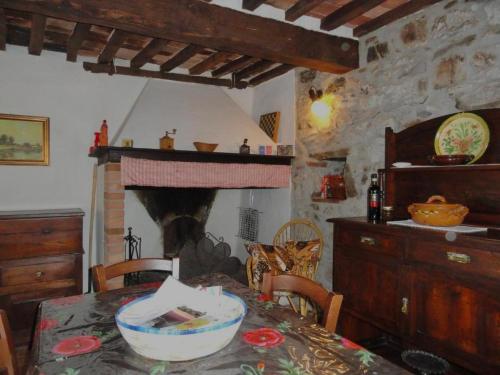 a dining room with a table and a fireplace at Borgo Petraio in Montieri