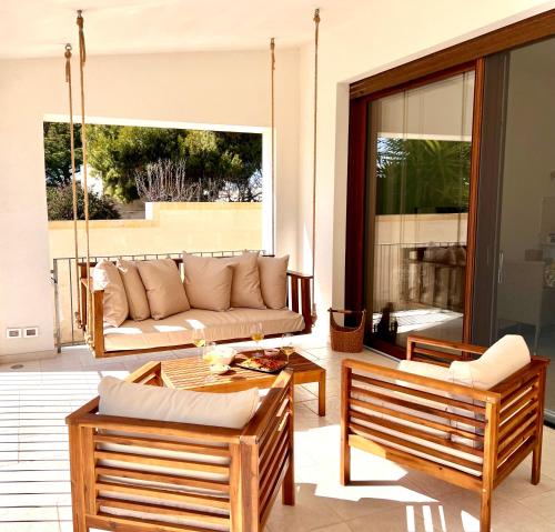 a living room with a couch and two chairs at Villa Afrodite in San Pietro in Bevagna