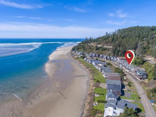 an aerial view of a beach with a red heart at Shoreline Solace: Ocean View Townhouse Tillamook in Tillamook