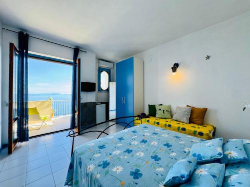 a bedroom with a bed and a large window at YourHome - Dimora di Mare in Amalfi