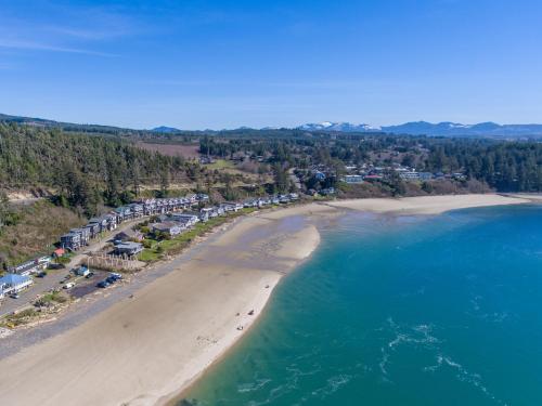 an aerial view of a beach with people on it at Shoreline Solace: Ocean View Townhouse Tillamook in Tillamook