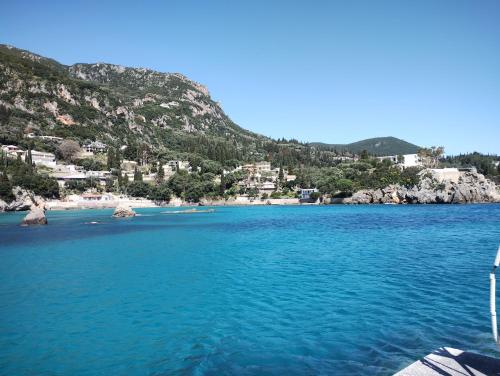 a view of a body of water with a mountain at Vanilla House Paleokastritsa in Paleokastritsa