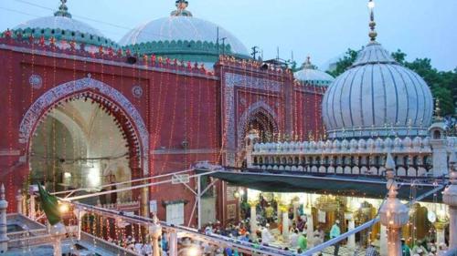 a large red building with domes on top of it at Hotel Royal Inn in New Delhi