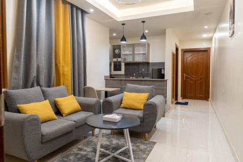 a living room with a couch and a table at AlNakheel Park Serviced Apartment Economy in Riyadh